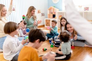 An experienced Montessori Guide supervising another teacher in a classroom.